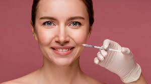 A woman receiving a facial filler injection to restore volume and smooth wrinkles on her face