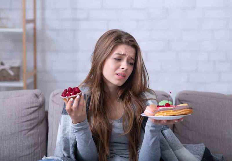 A woman looking sad and overwhelmed, reflecting the emotional struggle of living with Bulimia Nervosa