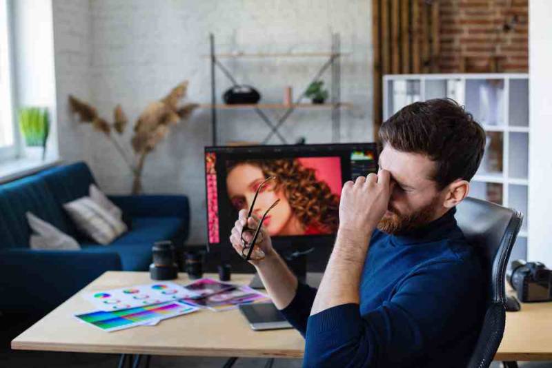 A stressed person sitting with their head in their hands, showing signs of emotional exhaustion and mental pressure from daily life challenges