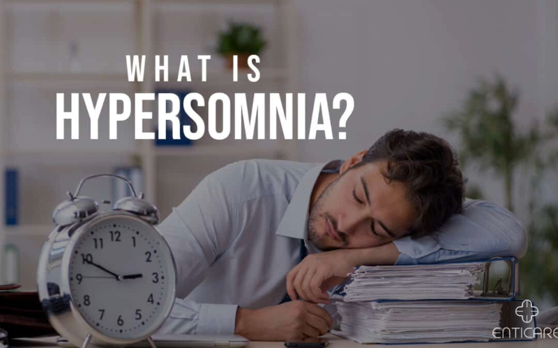 Person asleep on a pile of books, illustrating excessive daytime sleepiness caused by hypersomnia