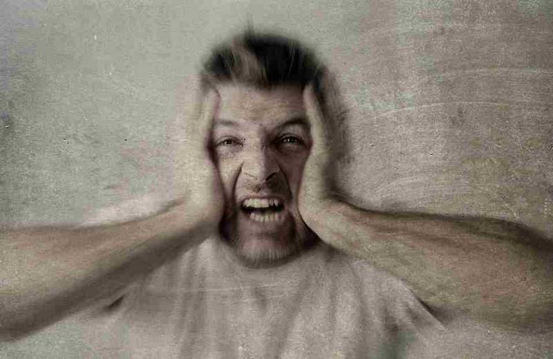 A distressed man shouting loudly, illustrating the emotional outburst and psychotic symptoms of schizophrenia