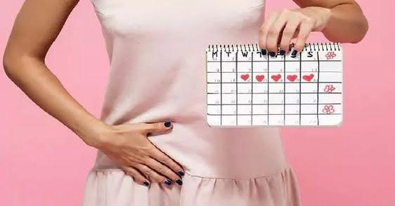 Woman holding a calendar and showing signs of concern, representing someone experiencing irregular menstrual cycles